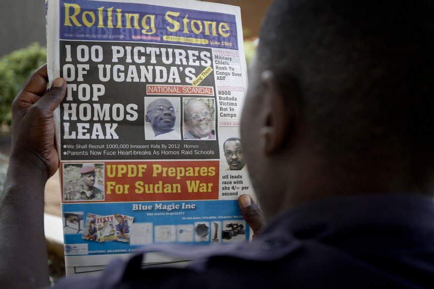 A Ugandan man reads the headline of the Ugandan newspaper &quot;Rolling Stone&quot; in Kampala, Uganda. Tuesday, Oct. 19, 2010, in which the papers reveals the identity of allegedly gay members of Uga ...
