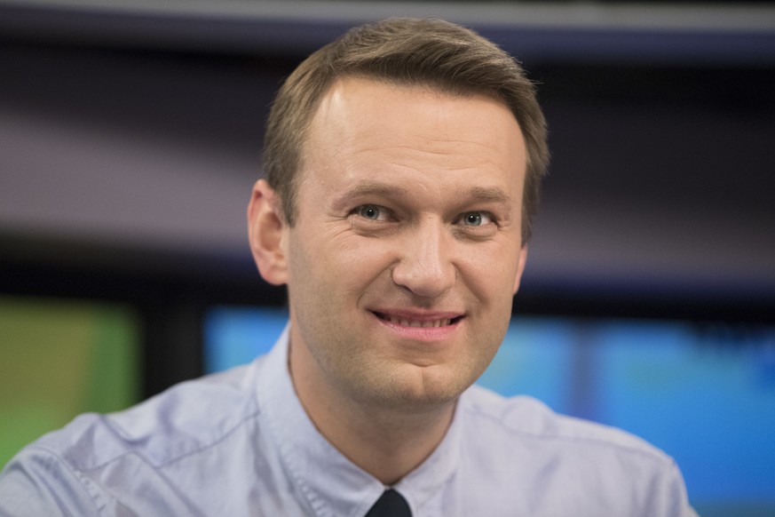 Russian opposition activist Alexei Navalny smiles during a broadcast at the Echo Moskvy (Echo of Moscow) radio station at the Echo Moskvy (Echo of Moscow) radio station in Moscow, Russia, Wednesday, D ...