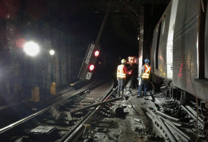 In this photo provided by the Transport Workers Union, Local 100, workers from the New York Metropolitan Transportation Authority respond to the scene of a subway derailment, Tuesday, June 27, 2017, i ...