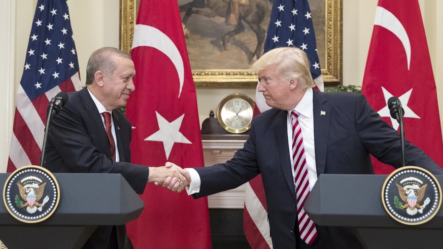 epa05968203 US President Donald J. Trump (R) shakes hands with President of Turkey Recep Tayyip Erdogan (L) in the Roosevelt Room where they issued a joint statement, at the White House in Washington, ...