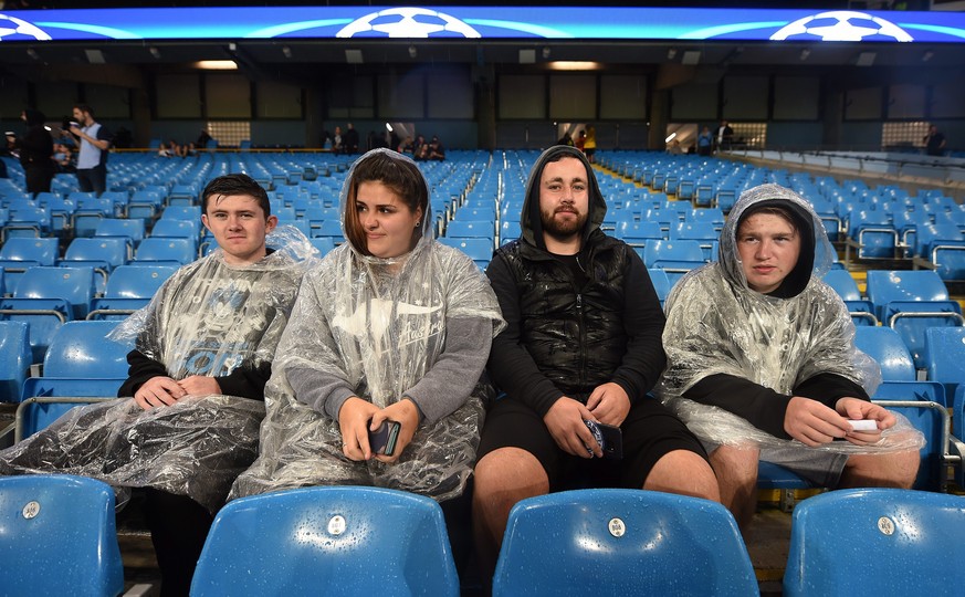 epa05538189 Manchester City fans sit in the stands as heavy rain falls before the UEFA Champions League Group C match between Manchester City and Borussia Monchengladbach held at the Etihad Stadium in ...