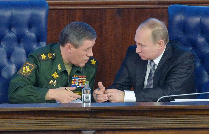 epa05065110 Russian President Vladimir Putin (R) talks with the Chief of Russian army general staff Valery Gerasimov (L), during Defence Ministry board meeting in Moscow, Russia, 11 December 2015. EPA ...