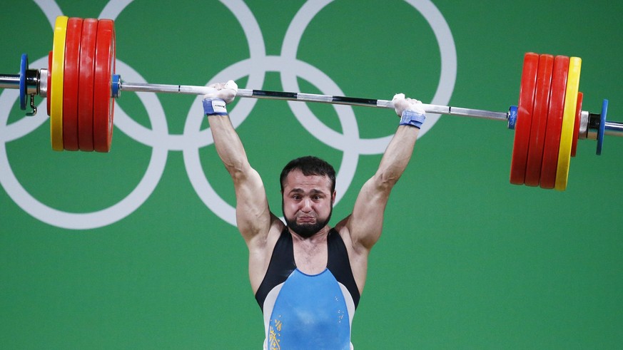 epa05472447 Nijat Rahimov of Kazakhstan during his his world record attempt in Clean &amp; Jerk in the men&#039;s 77kg category final of the Rio 2016 Olympic Games Weightlifting events at the Riocentr ...