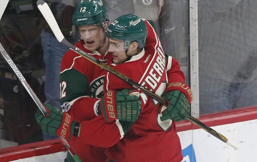 Minnesota Wild&#039;s Eric Staal, left, and Nino Niederreiter of Switzerland celebrate Staal&#039;s goal off Arizona Coyotes goalie Louis Domingue during the first period of an NHL hockey game Thursda ...