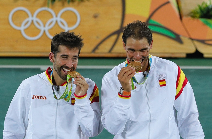 Spain Rafael Nadal, right, and Marc Lopez pose with the gold medals after defeating Romania&#039;s Horia Tecau and Florin Mergea in the men&#039;s doubles tennis competition at the 2016 Summer Olympic ...