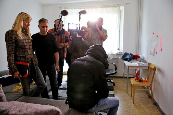 epa05581004 Ammar from Syri (R), a neighbour of the Syrian in whose apartment a suspected terrorist was arrested on 10 October 2016, sits in his apartment in Leipzig, Germany, 11 October 2016. The 22- ...