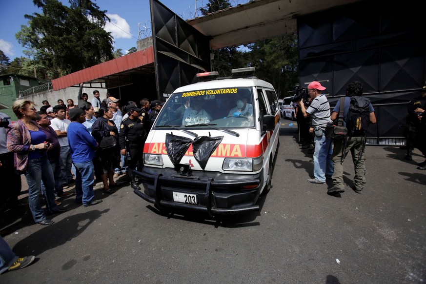 An ambulance carrying the bodies of those killed in the fire exits the Virgen de Asuncion home, in San Jose Pinula, on the outskirts of Guatemala City, Guatemala March 8, 2017. REUTERS/Saul Martinez