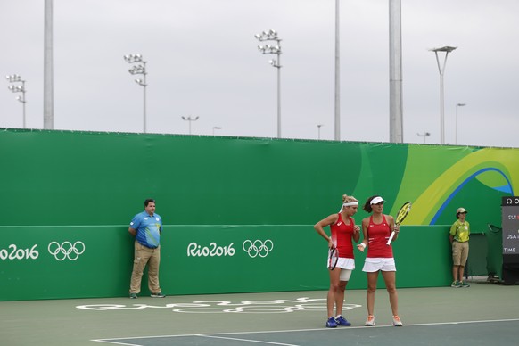 Timea Bacsinszky, left, and Martina Hingis of Switzerland discuss during the women’s second round doubles match against Bethanie Mattek-Sands and Coco Vandeweghe of USA at the Olympic Tennis Center in ...
