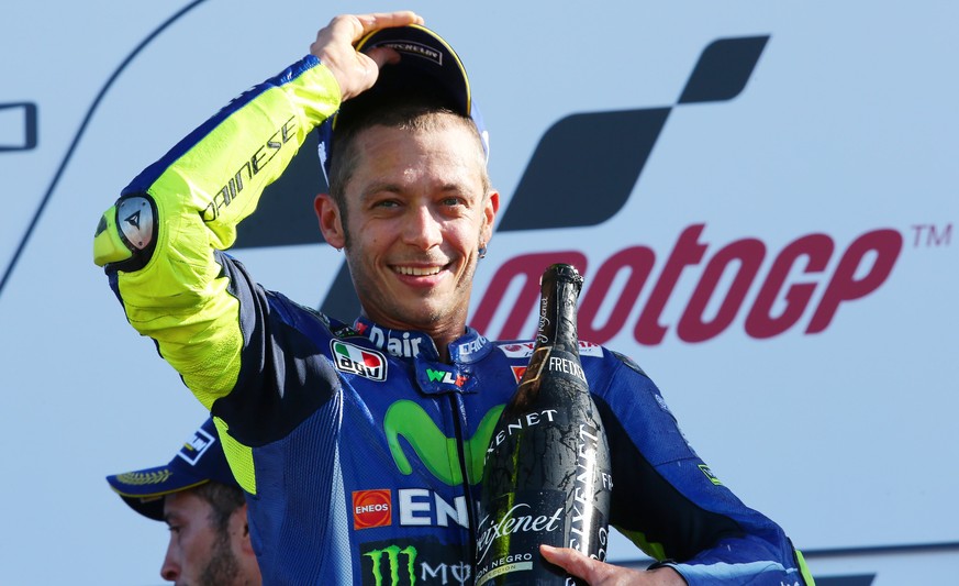 epa06166909 Italian Moto GP rider Valentino Rossi of the Movistar Yamaha MotoGP team celebrates his 3rd place on the podium during the MotoGP race of the 2017 British Motorcycling Grand Prix at the Si ...