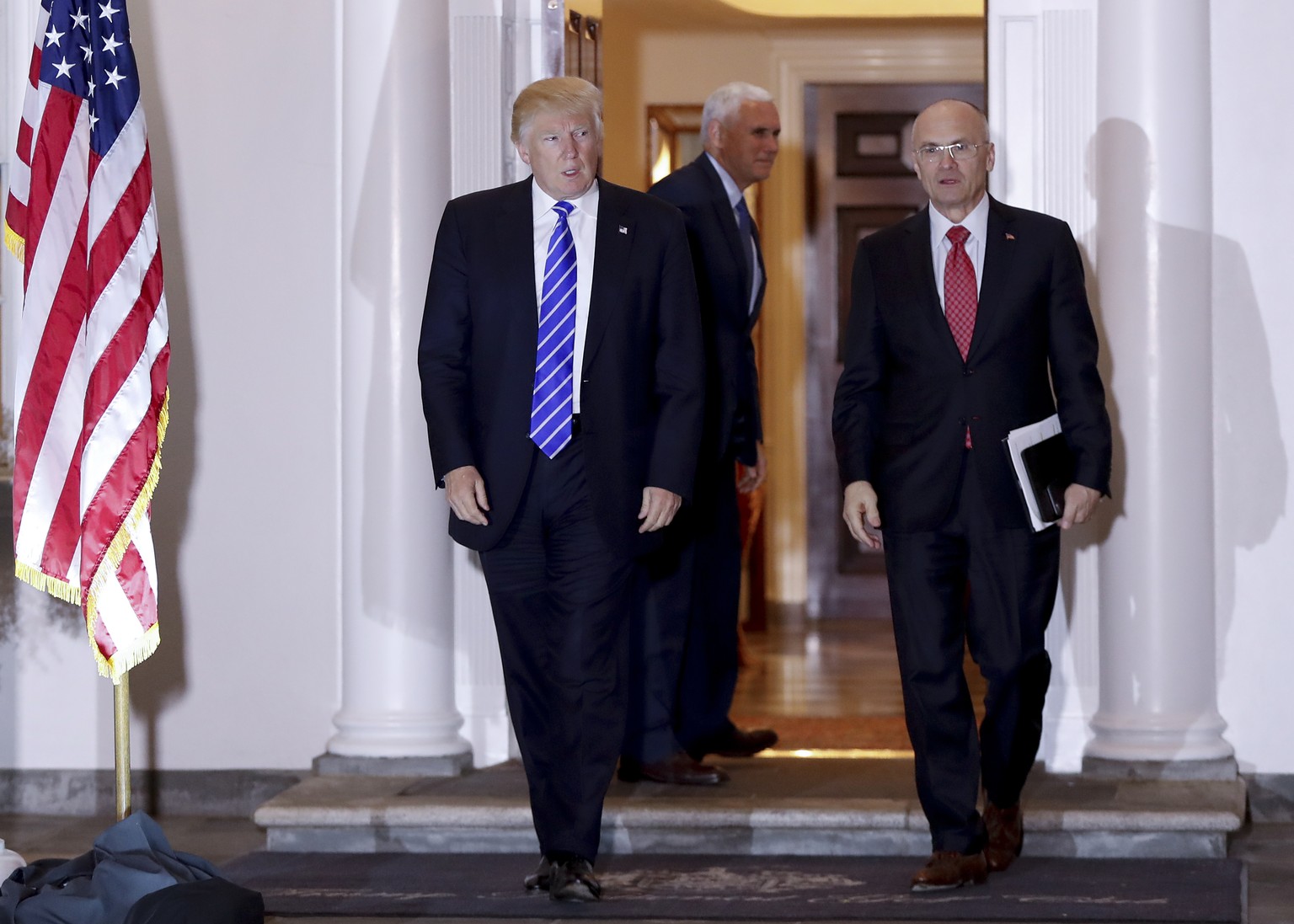 FILE - In this Nov. 19, 2016 file photo, President-elect Donald Trump walks with CKE Restaurants CEO Andy Puzder from Trump National Golf Club Bedminster clubhouse in Bedminster, N.J. Trump is expecte ...