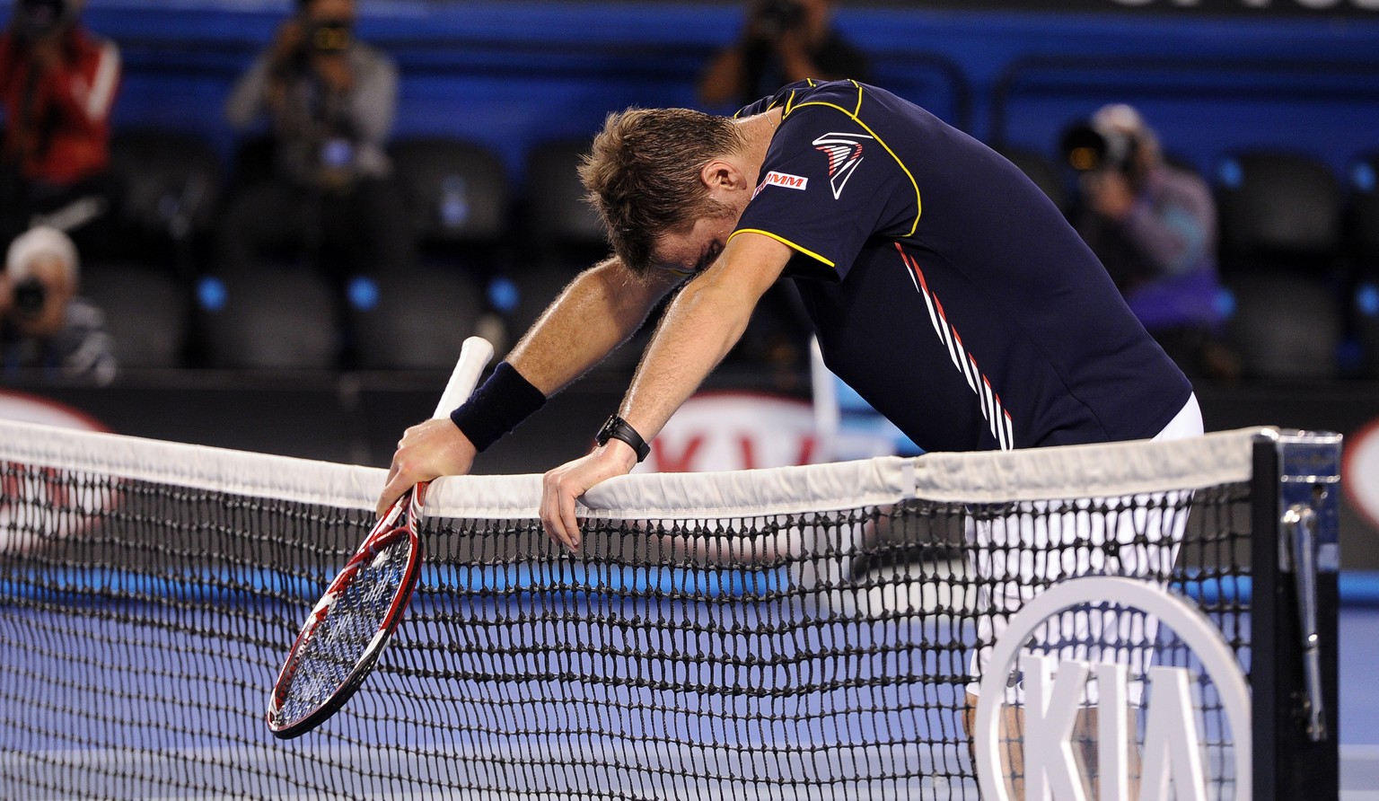 Switzerland&#039;s Stanislas Wawrinka rests on the net after losing his fourth round match against Serbia&#039;s Novak Djokovic at the Australian Open tennis championship in Melbourne, Australia, Sund ...