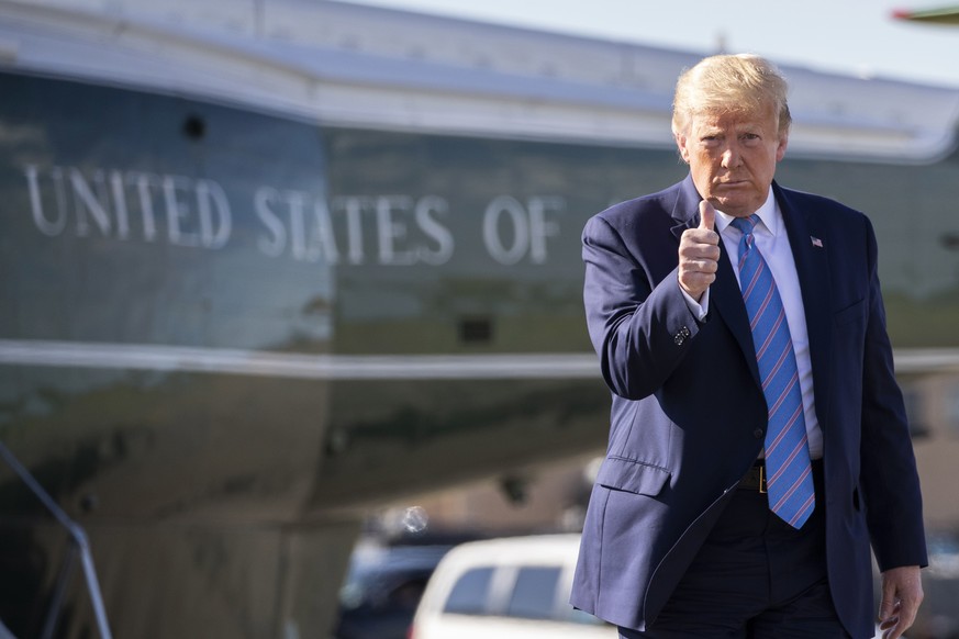 President Donald Trump gives a thumbs-up while walking across the tarmac as he boards Air Force One at Morristown Municipal Airport, Sunday, June 14, 2020, in Morristown, N.J. Trump is returning to Wa ...