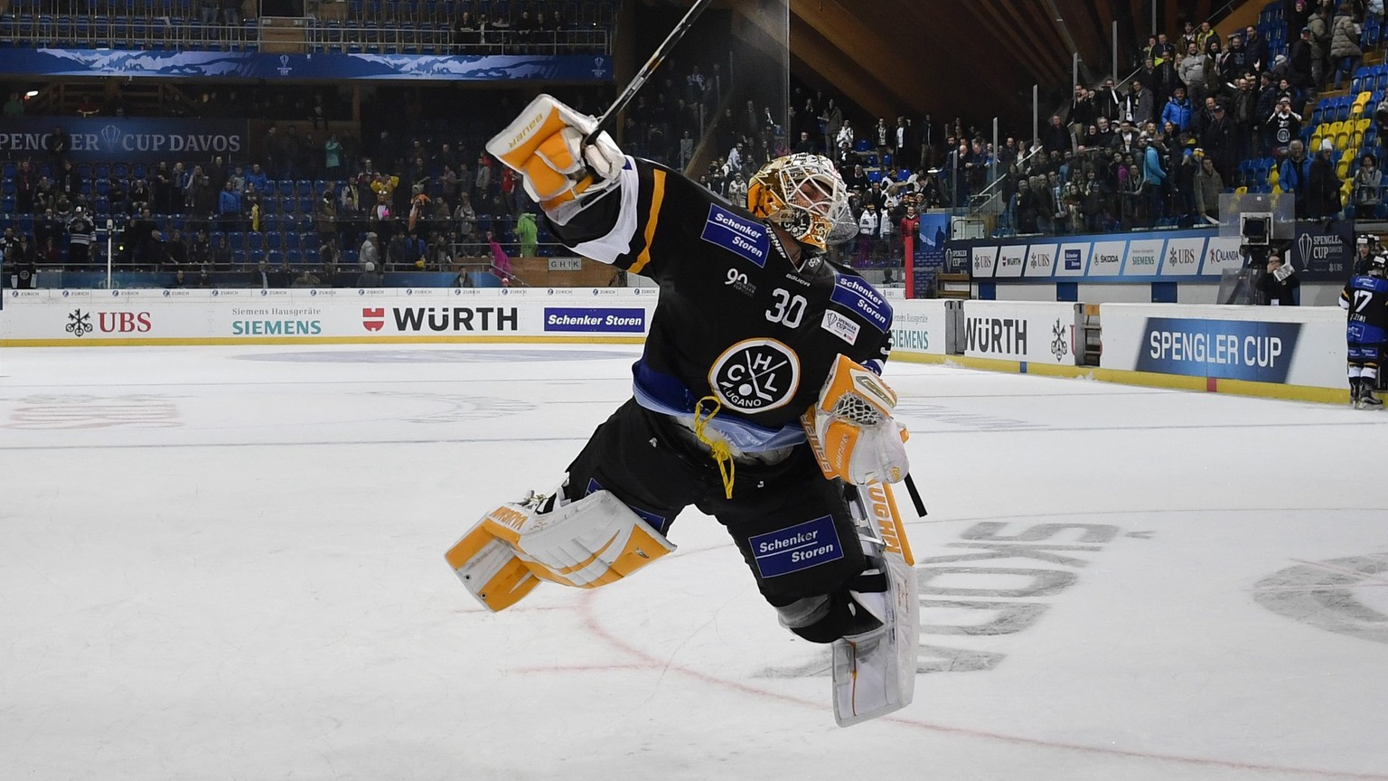 epa05688760 Lugano&#039;s goalkeeper Elvis Merzlikins celebrates after the game between HC Lugano and Avtomobilist Yekaterinburg, at the 90th Spengler Cup ice hockey tournament in Davos, Switzerland,  ...