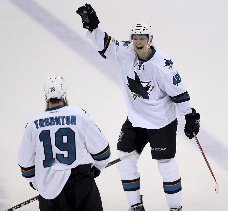 San Jose Sharks&#039; Joe Thornton (19) and and Tomas Hertl (48) celebrate after a goal by Joe Pavelski (8) against the Winnipeg Jets during third period NHL hockey action in Winnipeg, Monday, March 6 ...