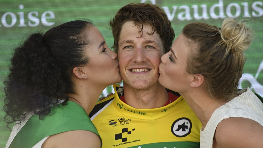 Stefan Kueng overall leader from Switzerland celebrates on podium after a 172,2 km stage with start and finish in Cham, Switzerland, at the 81st Tour de Suisse UCI ProTour cycling race, on Sunday, Jun ...