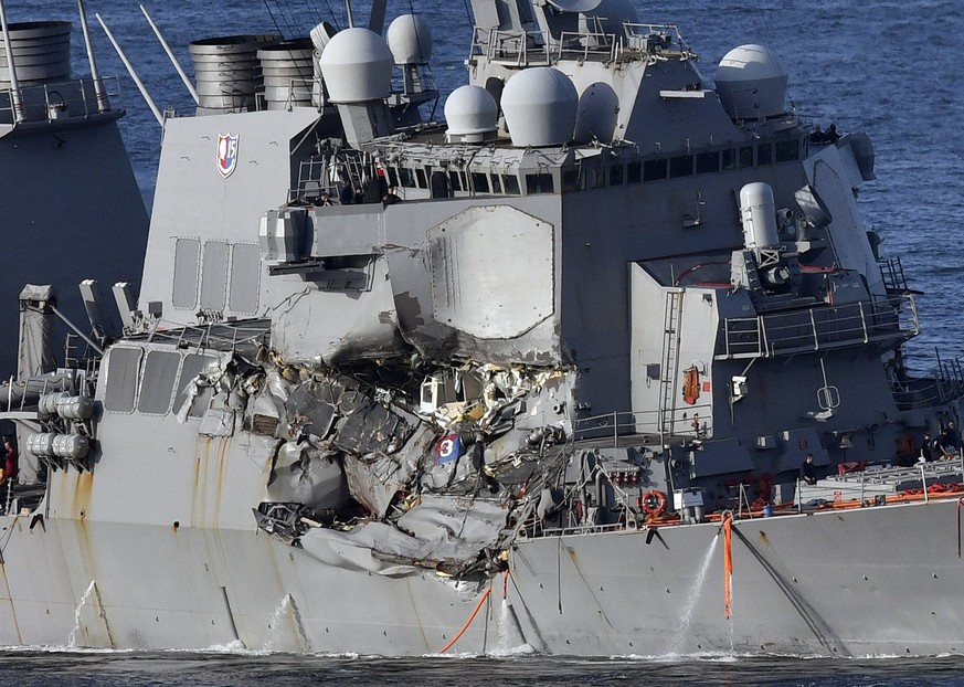 epa06032598 A view of a damaged area of the US Navy destroyer USS Fitzgerald as it returns to Yokosuka Naval Base after its collision with the container ship ACX Crystal off the coast of Yokosuka, Jap ...