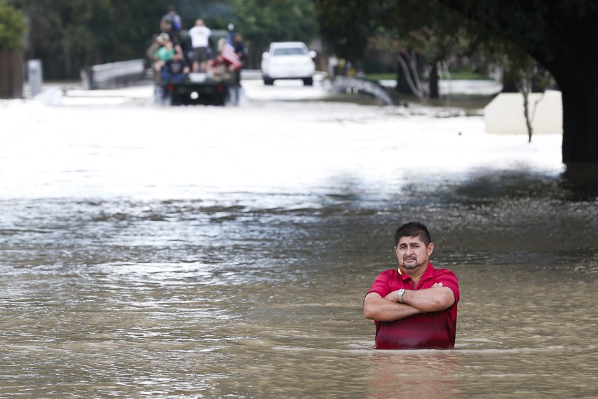 A man stands in deep flood water along West Little York Road as Addicks Reservoir surpasses capacity due to near constant rain from Tropical Storm Harvey Tuesday, Aug. 29, 2017 in Houston. ( Michael C ...