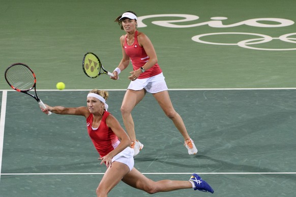 Timea Bacsinszky, left, and Martina Hingis, right, of Switzerland during the women&#039;s semi-final doubles match against Andrea Hlavackova and Lucie Hradecka from Czech Republic at the Olympic Tenni ...