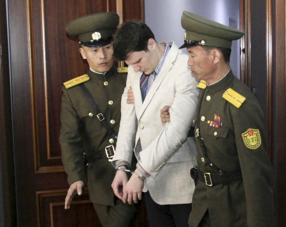 FILE - In this March 16, 2016, file photo, American student Otto Warmbier, center, is escorted at the Supreme Court in Pyongyang, North Korea. Warmbier, whose parents say has been in a coma while serv ...