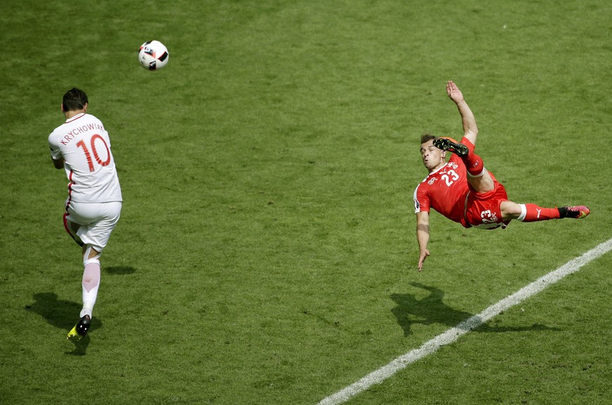 epa05601735 YEARENDER 2016 JUNE
Xherdan Shaqiri of Switzerland (R) scores a goal as Grzegorz Krychowiak of poland tries to defend, during their UEFA EURO 2016 round of 16 match at the Stade Geoffroy  ...