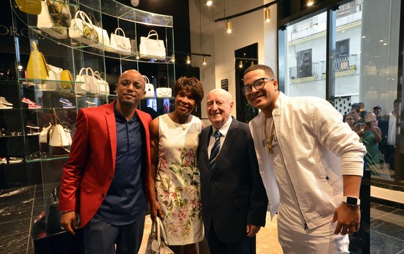 epa05922354 The Italian businessman Giorgio Gucci (2-R), poses with the Cuban former athlete Ana Fidelia Quirot (2-L) and the reggaeton singers Yomil (R) and El Dany (L), in one of the new luxury shop ...