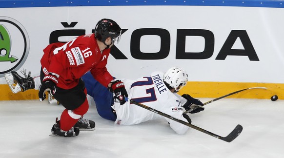 Switzerland&#039;s Raphael Diaz, left, challenges France&#039;s Sacha Treille, right, during the Ice Hockey World Championships group B match between Switzerland and France in the AccorHotels Arena in ...