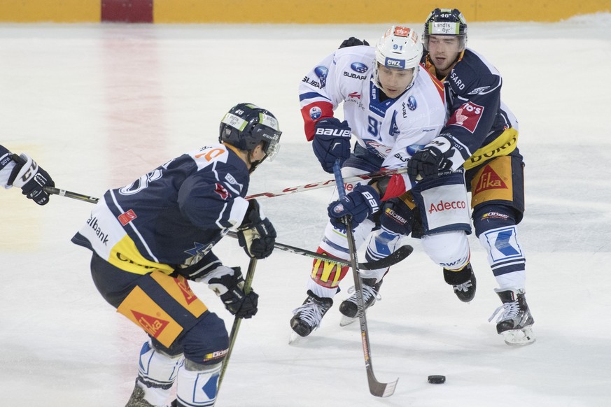 Inti Pestoni, Mitte, vom ZSC im Duell gegen Carl Klingberg, rechts, von Zug im Eishockey Meisterschaftsspiel zwischen dem EV Zug und den ZSC Lions, am Dienstag, 13. September 2016, in Zug. (KEYSTONE/U ...