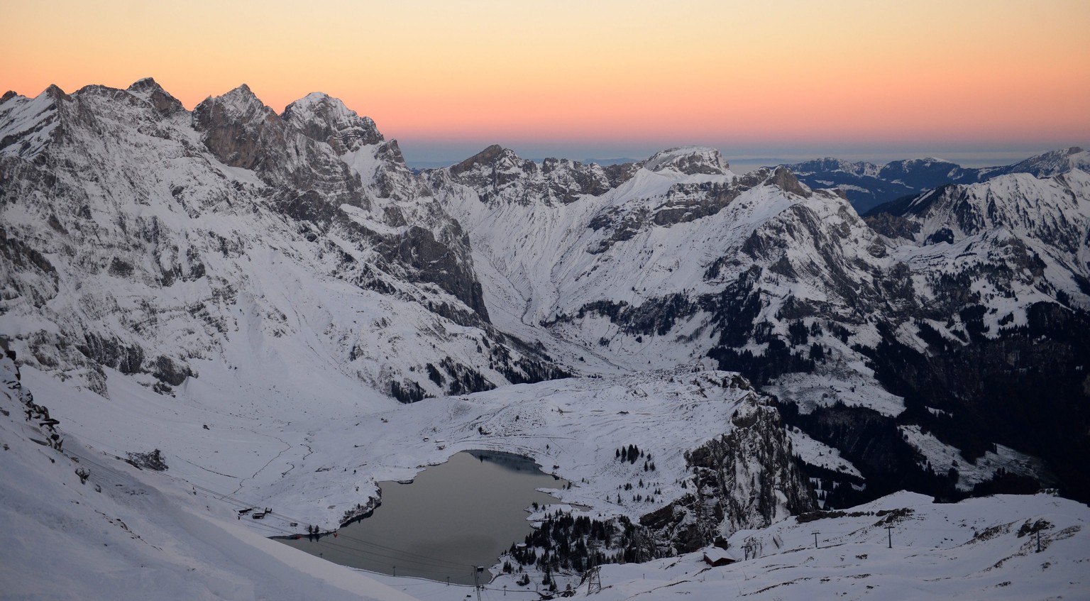 epa04461186 Sunset behind the Engelberg Alps and the Truebsee lake in Engelberg Canton Obwalden seen from Titlis-Stand Station, Switzerland, 24 October 2014. EPA/URS FLUEELER