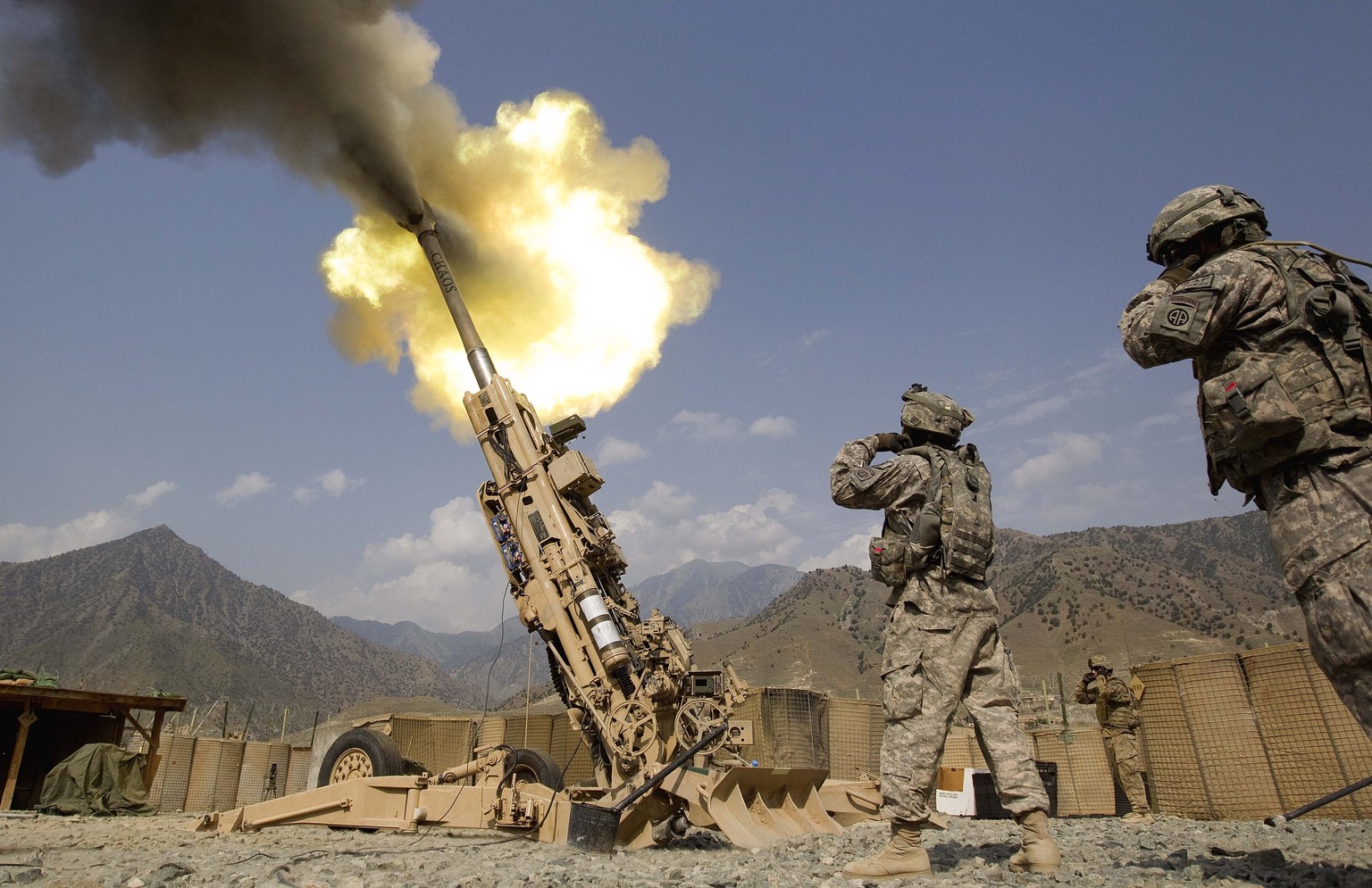 FILE - A 155mm round is fired from a 777 Howitzer canon at insurgents during a firing mission by soldiers with 2nd Platoon, Charlie Battery, 3rd Battalion, 321 Field Artillery Regiment out of Fort Bra ...