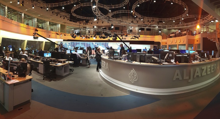 In this Thursday, June 8, 2017 photo, Al Jazeera staff work at their TV station in Doha, Qatar. The Arab news network Al-Jazeera has been thrust into the center of the story this week as Qatar came un ...