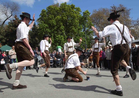 People wearing traditional Lederhosen trousers perform a dance at the annual Styria festival promoting Austria&#039;s Styria province, in Vienna April 11, 2014. REUTERS/Heinz-Peter Bader (AUSTRIA - Ta ...
