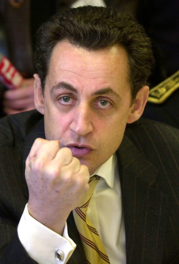 French Interior Minister Nicolas Sarkozy gestures as he talks with young residents in the Pau district of l'Ousse-des-bois, southwestern France, Friday, Dec. 19, 2003. Sarkozy is touring the sout ...