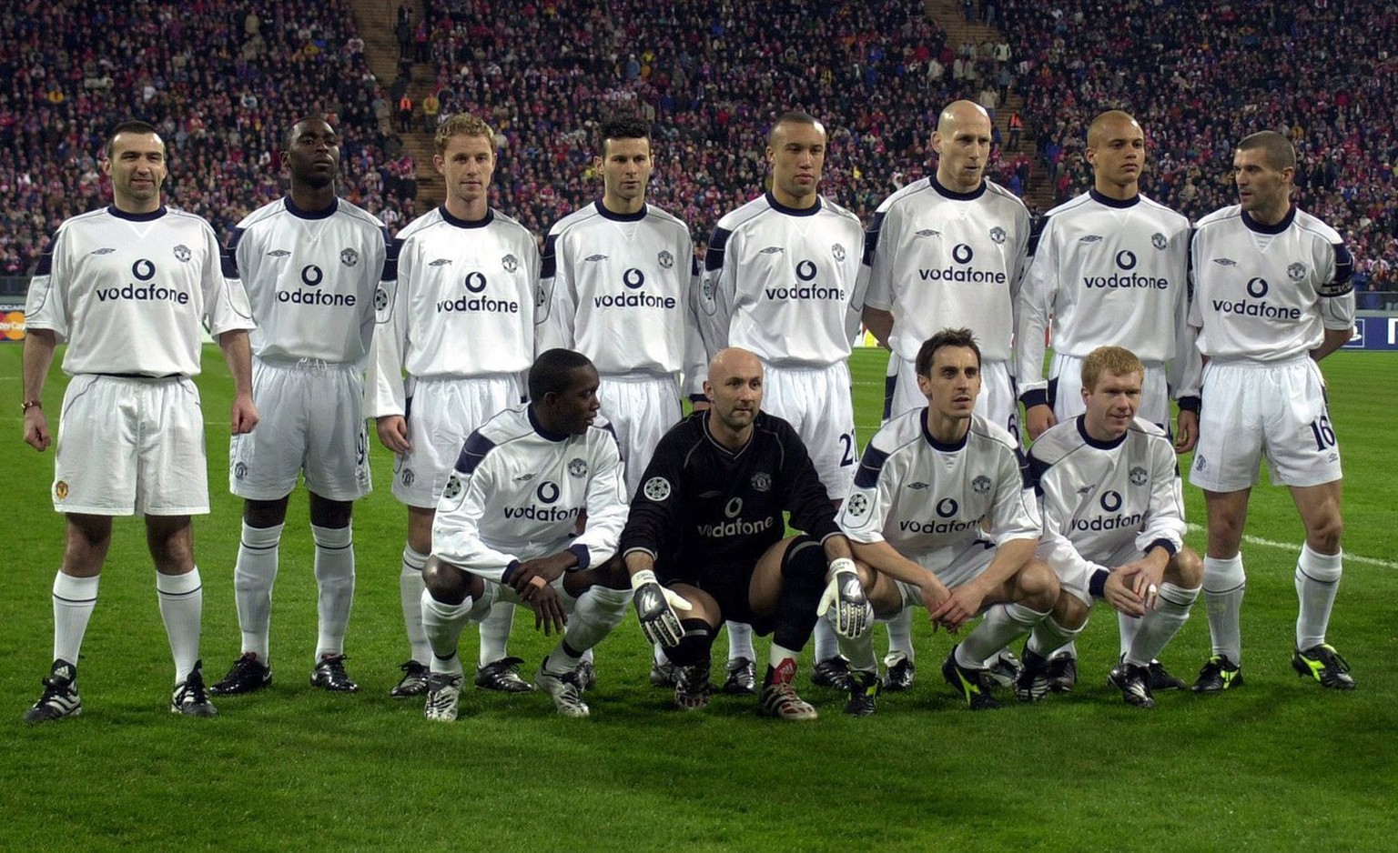 An Eric Cantona look-alike, in full soccer kit (extreme left) gate-crashes a team photo of Manchester United before the Champions League quarter final game against Bayern Munich. The identity of the b ...