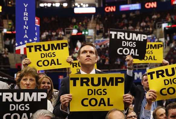 Delegates from West Virginia hold signs supporting coal on the second day of the Republican National Convention in Cleveland, Ohio, U.S. July 19, 2016. REUTERS/Aaron P. Bernstein/File Photo