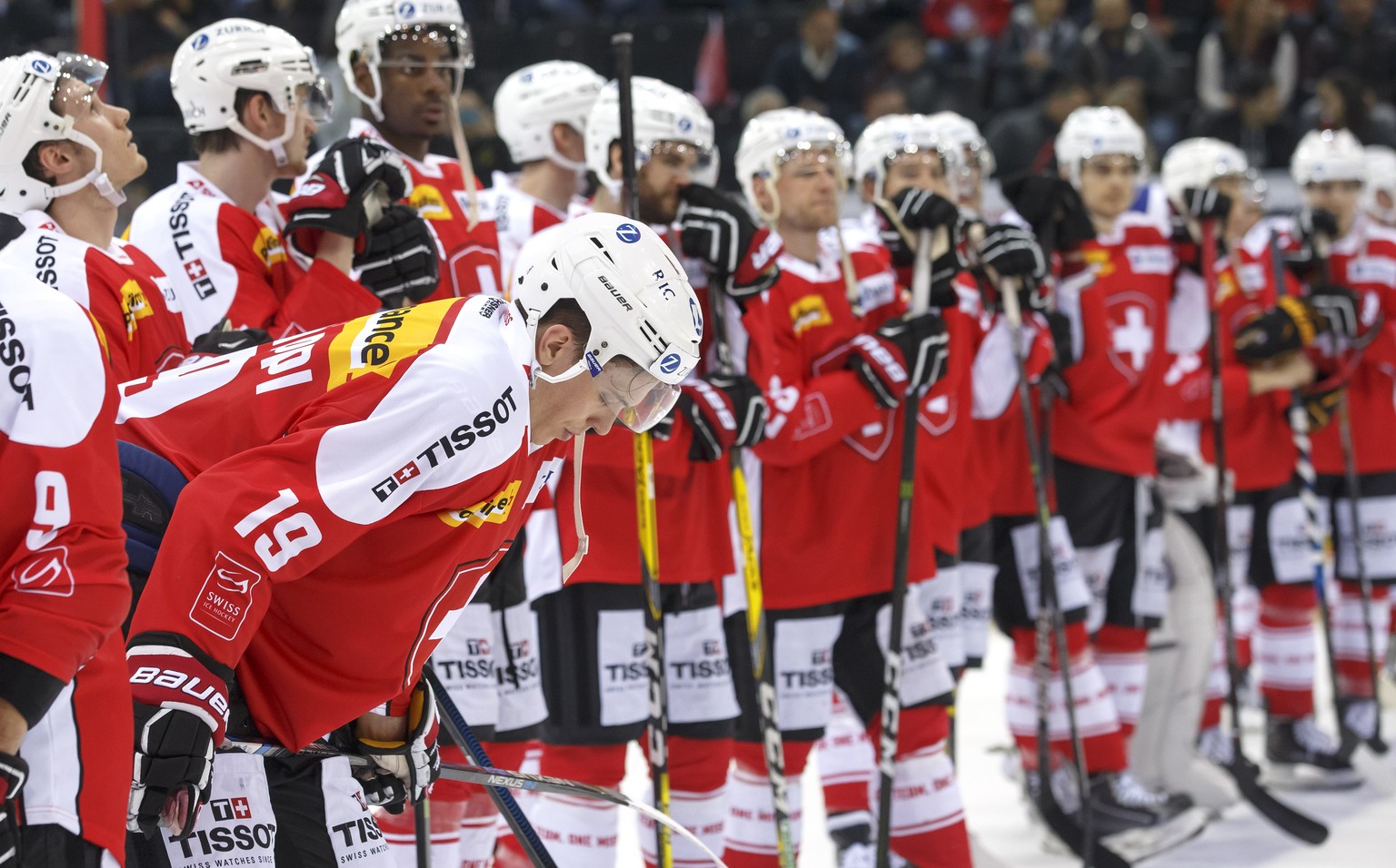 Switzerland&#039;s forward Reto Schaeppi #19 and his teammates react after losing against Canada, during a friendly international ice hockey game between Switzerland and Canada, at the ice stadium Les ...