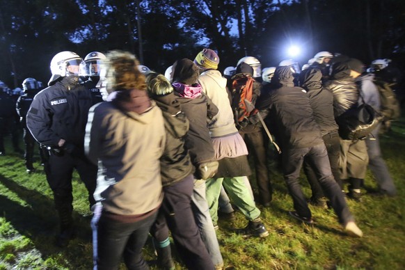 In this July 2, 2017 photo police clash with demonstrators after a raid at a camp of protesters against the G20 summit in Hamburg, Germany. (Bodo Marks/dpa via AP)