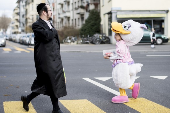 Children and grownups celebrate Purim in the Wiedikon district of Zurich, Switzerland, pictured on Thursday, March 5, 2015. Purim is a festival commemorating the deliverance of the Jewish people from  ...