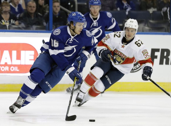 Tampa Bay Lightning center Brayden Point (36) moves the puck around Florida Panthers forward Denis Malgin (62) during the first period of an NHL preseason hockey game Thursday, Sept. 29, 2016, in Tamp ...