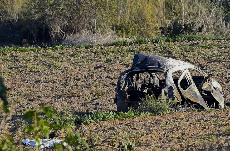 The wreckage of the car of investigative journalist Daphne Caruana Galizia lies next to a road in the town of Mosta, Malta, Monday, Oct. 16, 2017. Malta&#039;s prime minister says a car bomb has kille ...