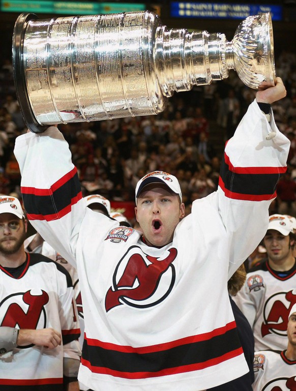 FILE - In this June 9, 2003, file photo, New Jersey Devils goaltender Martin Brodeur hoists the Stanley Cup after the Devils defeated the Anaheim Mighty Ducks 3-0 in Game 7 of the Stanley Cup Finals i ...