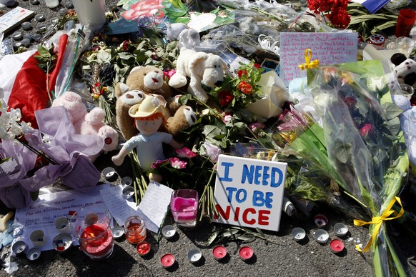 Flowers are placed at the scene of a truck attack on the famed Promenade des Anglais in Nice, southern France, Monday, July 18, 2016, prior to a minute of silence to honor the victims of the Bastille  ...