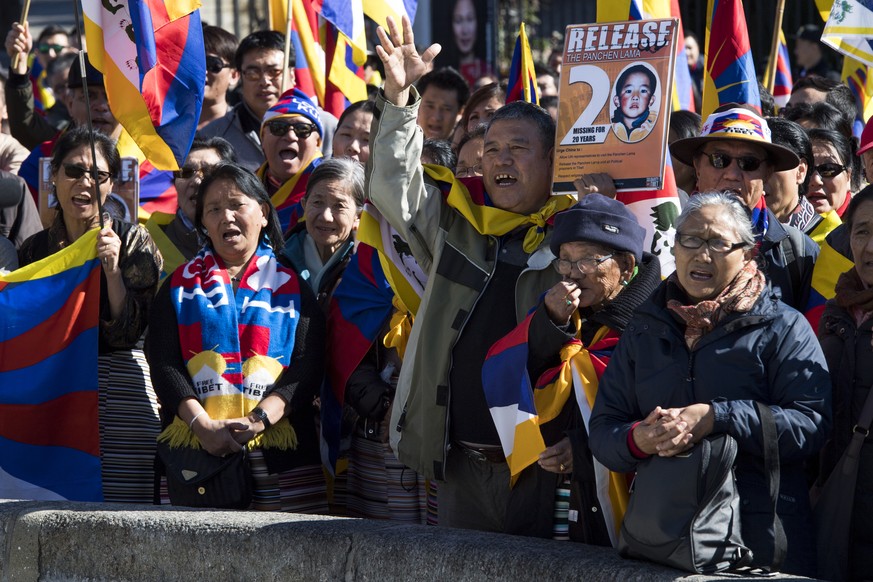 People gather to mark the 58th anniversary of the Tibetan National Uprising Day, while protesting against Chinese rule in Tibet, in Bern, Switzerland, on Friday, March 10, 2017. The Tibetan Uprising D ...