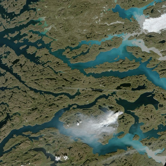 epa06153447 A handout photo made available on 20 August 2017 by Nasa Earth Observatory showing a wildfire burning in western Greenland, about 150 kilometers (90 miles) northeast of Sisimiut on 03 Augu ...