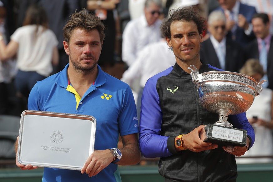 Spain&#039;s Rafael Nadal, right, and Switzerland&#039;s Stan Wawrinka pose with their trophy after their final match of the French Open tennis tournament at the Roland Garros stadium, Sunday, June 11 ...