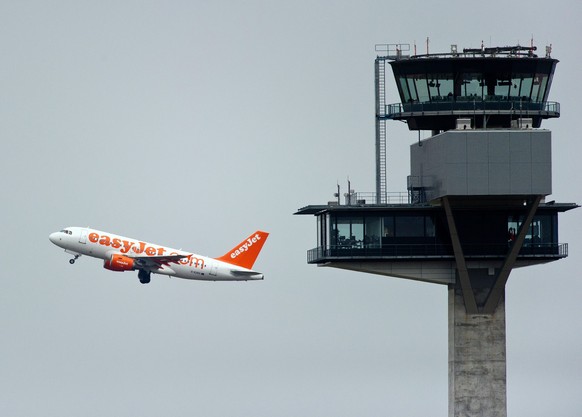 epa05401384 (FILE) A file photo dated 07 September 2012 showing an airplane of the budget airline easyJet taking off next to the new tower of the Berlin Brandenburg Airport Willy Brandt (BER) in Schoe ...