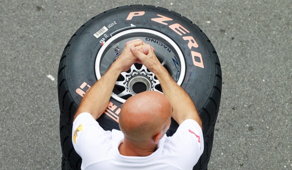 epa04931901 (FILE) A file picture dated 22 September 2011 of a Renault mechanic in front of a pile of tires at the Marina Bay Street Circuit in Singapore, prior to the Singapore Formula One Grand Prix ...