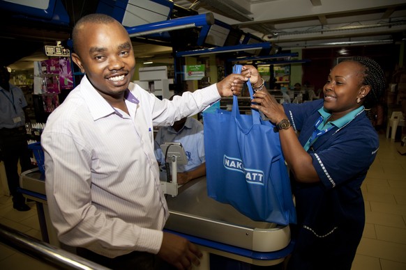 A customer carries his shopping in a cloth carrier bag in Nairobi, Kenya, Monday, Aug. 28, 2017. A ban on plastic bags came into force Monday in Kenya and those found violating the new regulation coul ...