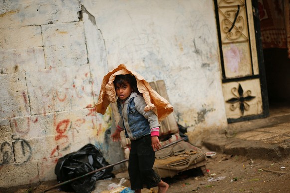 A Palestinian girl walks outside her family house following heavy rain in a neighbourhood in the northern Gaza Strip February 16, 2017. REUTERS/Mohammed Salem