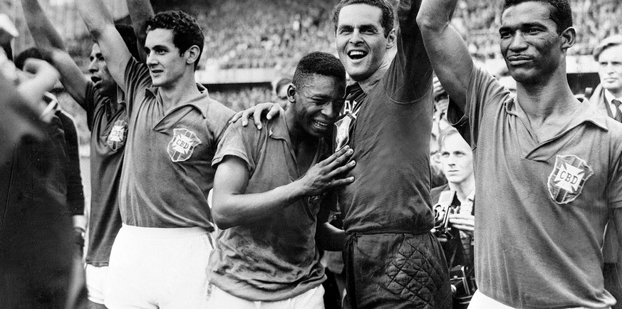 Brazil&#039;s 17- year-old star Pele, center, weeps on the shoulder of goalkeeper Gylmar Dos Santos Neves after Brazil&#039;s 5-2 victory over Sweden in the final of the World Cup tournament in Stockh ...