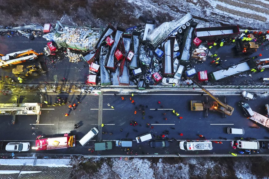 In this Monday, Nov. 21, 2016 photo released by Xinhua News Agency, rescuers work near vehicles collided on the Pingyang section of Beijing-Kunming expressway in north China&#039;s Shanxi Province. A  ...